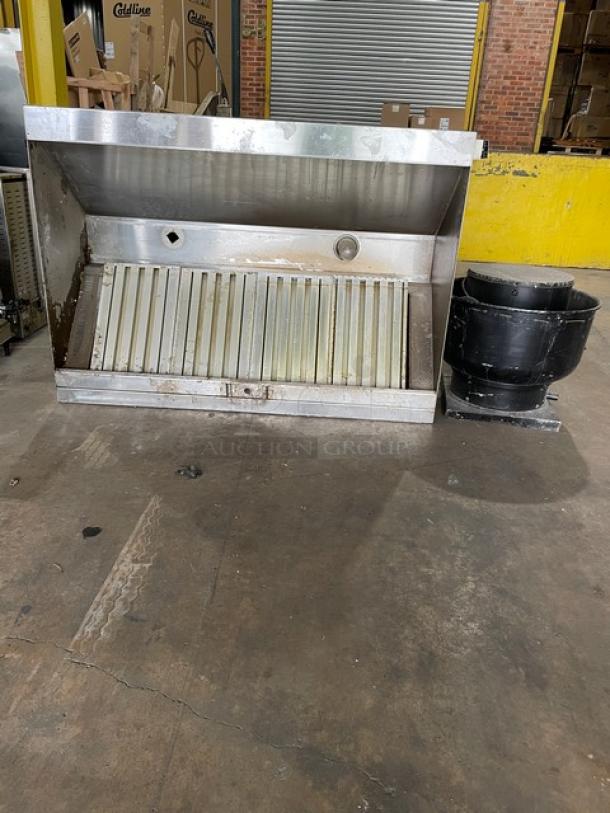 Commercial stainless steel kitchen exhaust hood with filter and electric exhaust fan. Some wear visible.