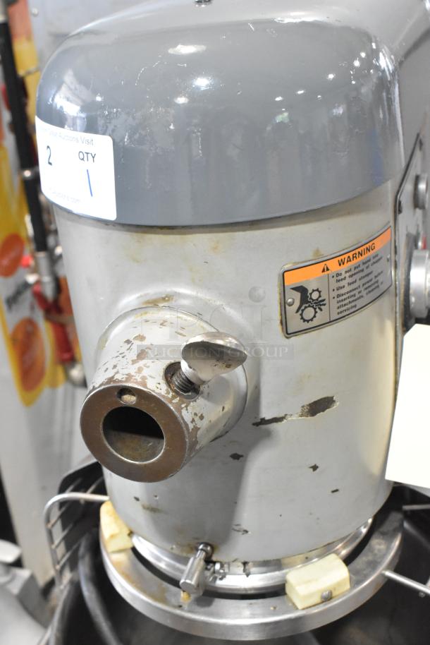 Hobart D3-40 40-quart planetary dough mixer, showing stainless steel bowl and worn exterior, includes warning label.