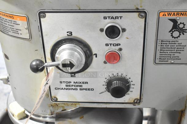 Hobart D3-40 mixer control panel with speed settings, start/stop buttons, and warning labels. Visible wear.