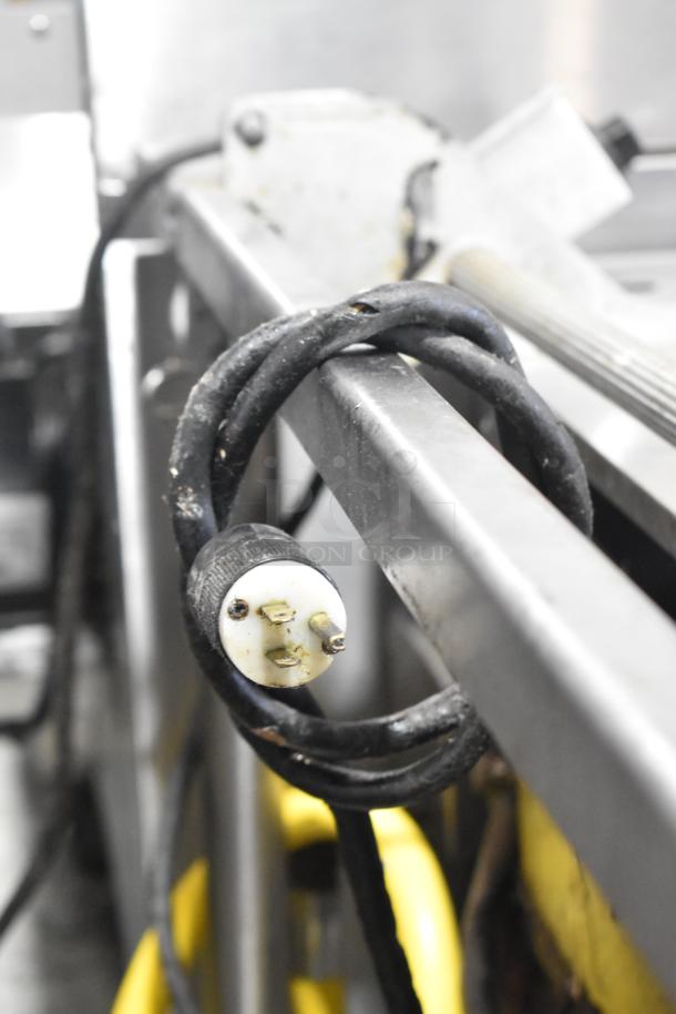Close-up of the plug and cord for Groen BPM-40G Braising Pan, showing wear. Stainless steel frame is partially visible.