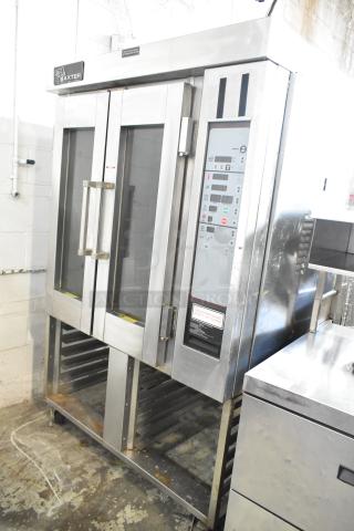 Baxter stainless steel mini rotating rack oven with dual pan rack and commercial casters. Features control panel, clean exterior.