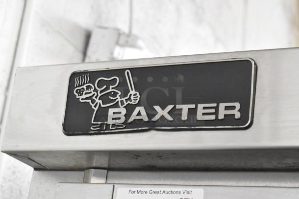 Baxter stainless steel commercial mini rotating rack oven with dual pan rack on casters. Features Baxter logo.