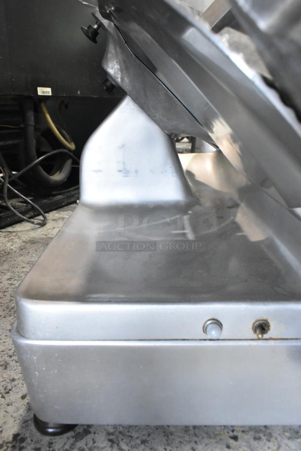 Hobart 1712 stainless steel commercial meat slicer, countertop model, automatic, 115 volts, some wear visible.