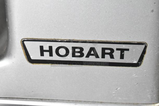 Hobart 1712 stainless steel commercial meat slicer, 115V, 1 phase, logo visible, used condition.
