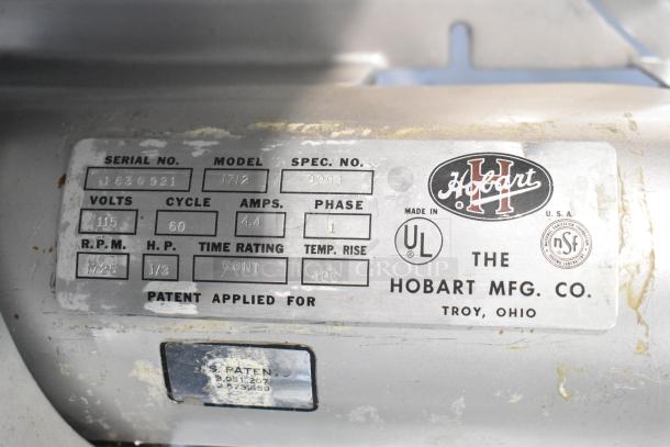 Hobart 1712 stainless steel automatic meat slicer, 115 volts, 1 phase, product label showing model and specs.