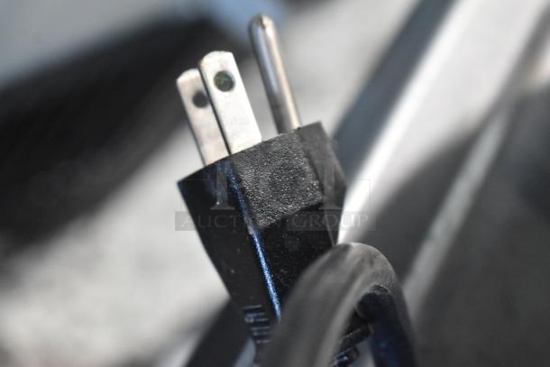 Close-up view of the power plug for a Berkel FMS20 commercial dough mixer with a standard two-prong configuration.