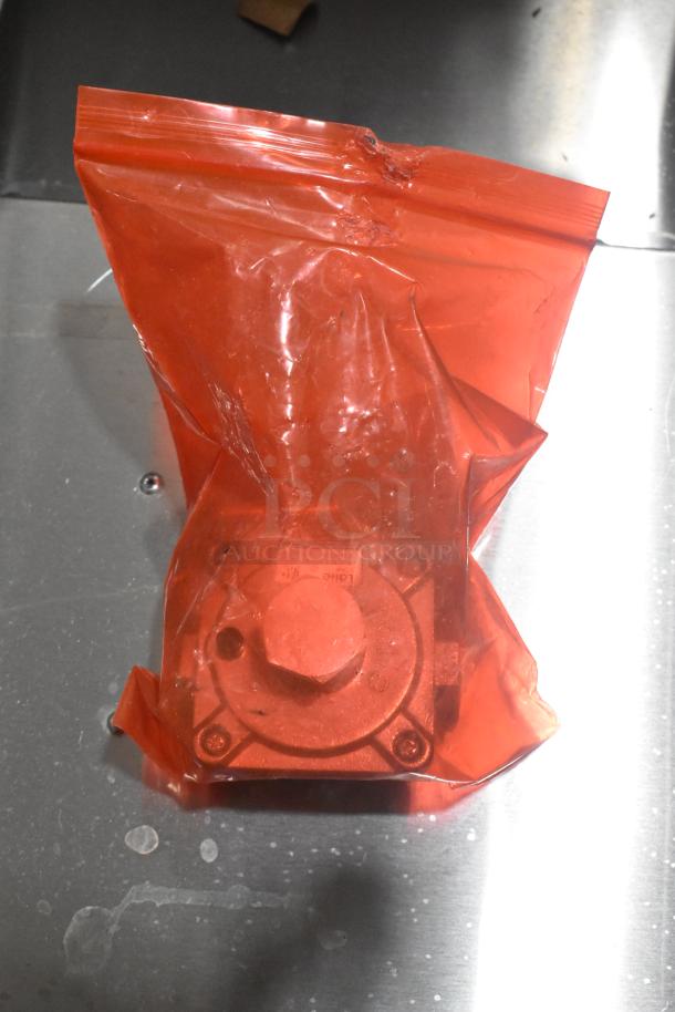 Stainless steel steam table component in a red protective bag. Item is part of the 2025 ServIt 423GST3WELP steam table.
