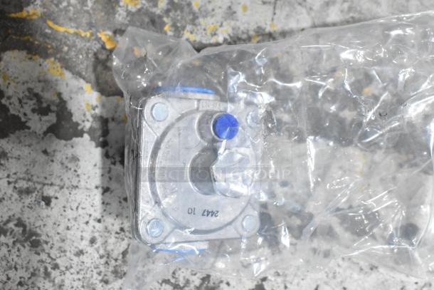Gas component wrapped in plastic packaging on a textured surface. Markings visible: "2417 10" and "VENT."; appears unused.