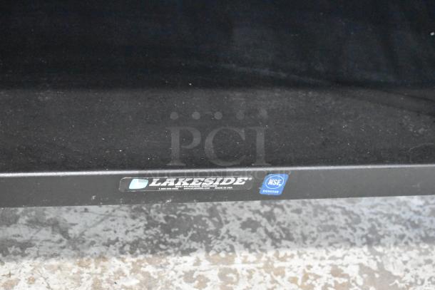 Lakeside metal commercial bakery display case rack with casters, 125 volts, 1 phase. Lakeside and NSF labels visible.