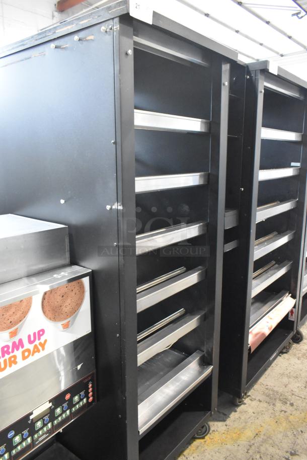 Vulcan 1015021 commercial bakery display case with shelves, on casters. Black metal, 125V, 1 phase, used condition.