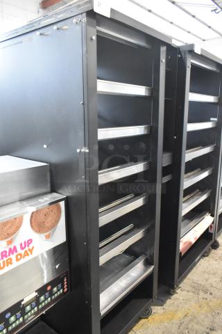 Vulcan 1015021 commercial bakery display case with shelves, on casters. Black metal, 125V, 1 phase, used condition.