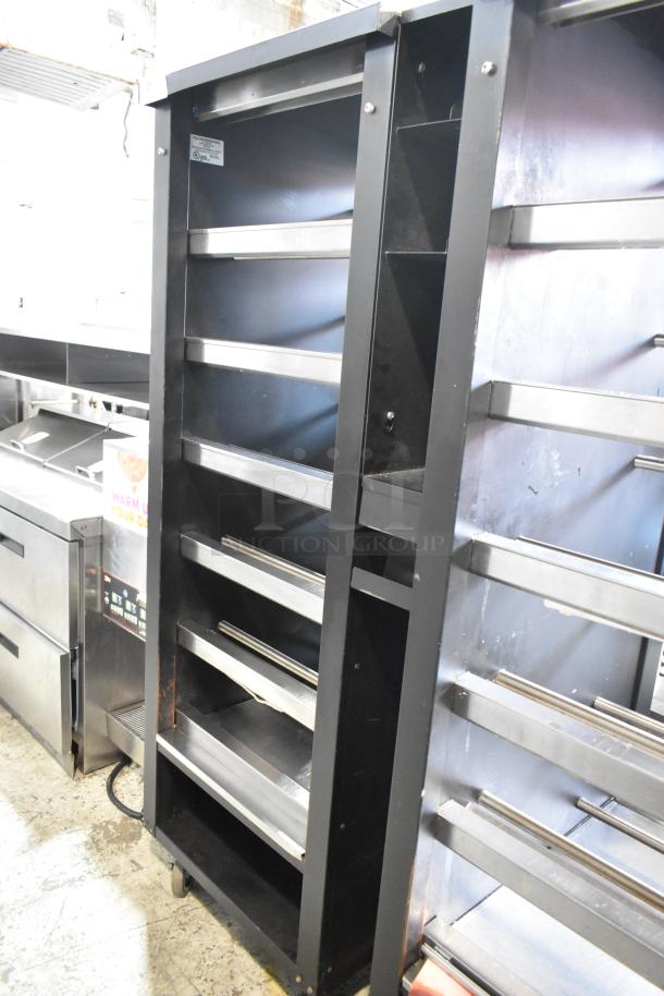 Vulcan 1015021 metal display case with shelves and commercial casters for bakery items. Black finish, 125V, 1 phase.