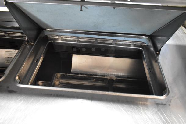 Delfield UCD4464N-12-DD5 stainless steel prep table interior, showing hinged lid and steel construction, suitable for commercial use.