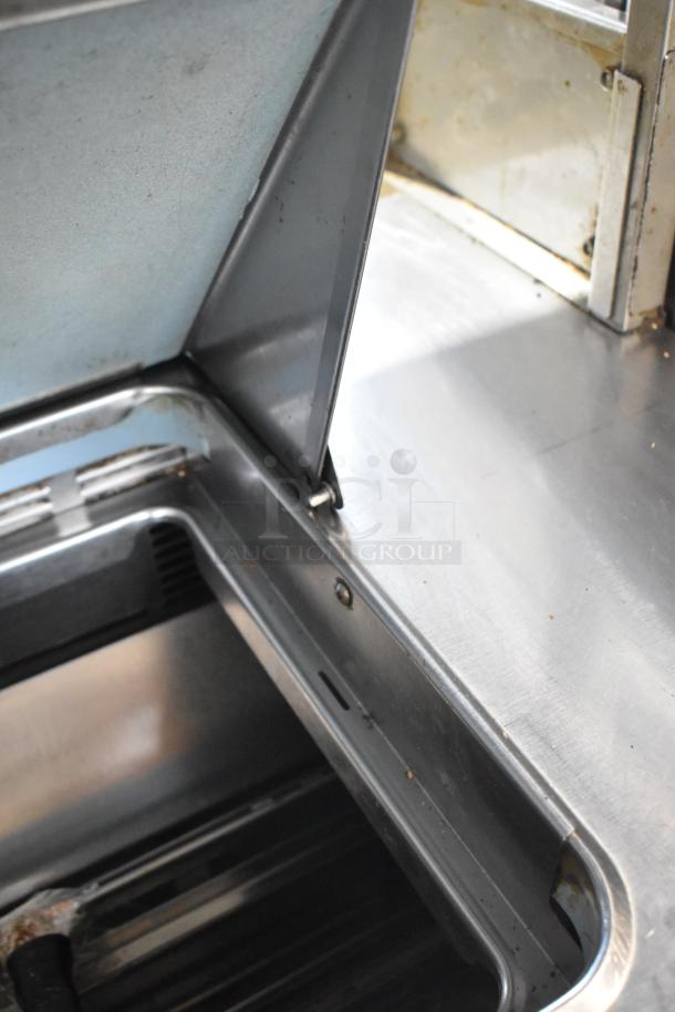 Delfield UCD4464N-12-DD5 sandwich salad prep table, stainless steel, visible interior basin, used condition.