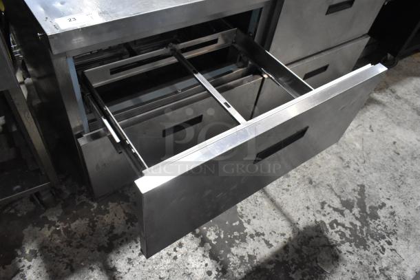 Delfield UCD4464N-12-DD5 stainless steel sandwich salad prep table with 4 drawers and an overshelf on casters.