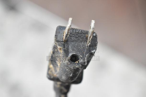 Close-up of a worn electrical plug for a Hatco Glo Ray Stainless Steel Commercial Heated Warming Case, 120V, 1 Phase.