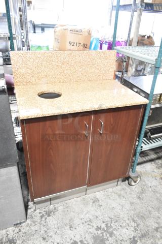 Wood pattern trash can shell with granite-style top, trash deposit hole, two doors, and metal handles. Good condition.