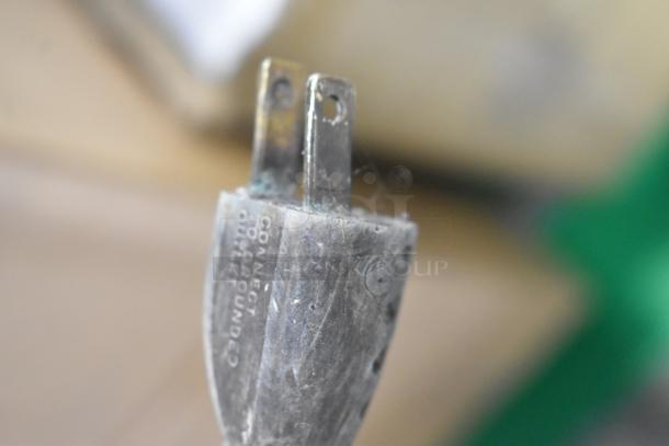 Plug of Hobart A 200 Commercial 20 Quart Dough Mixer, showing slightly worn prongs and "connect to grounded outlet" text.