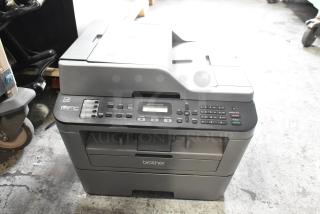 Brother MFC-L2700DW printer with copier and scanner, used condition. Features control panel, document feeder, and output tray.