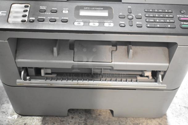 Brother MFC-L2700DW scanner and printer, features WiFi, fax, scan, and copy functions. Slight wear visible on control panel.