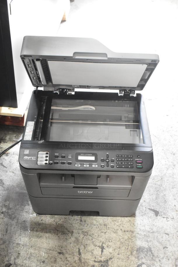 Brother MFC-L2700DW countertop scanner copier printer; open lid, keypad visible, model number displayed, good condition.