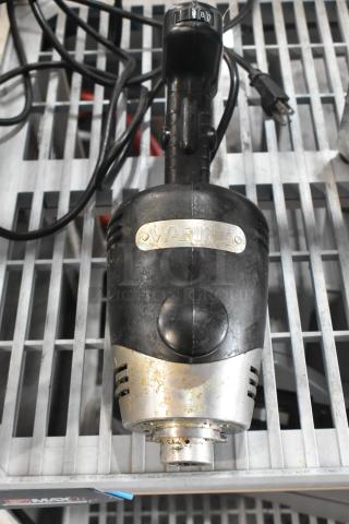 Waring WSB immersion blender base, 120V, 1 phase. Visible wear, model tag intact. Black and silver finish.