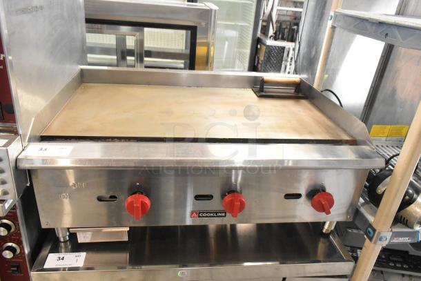 Cookline stainless steel commercial gas griddle with red knobs and brand logo, in good condition.