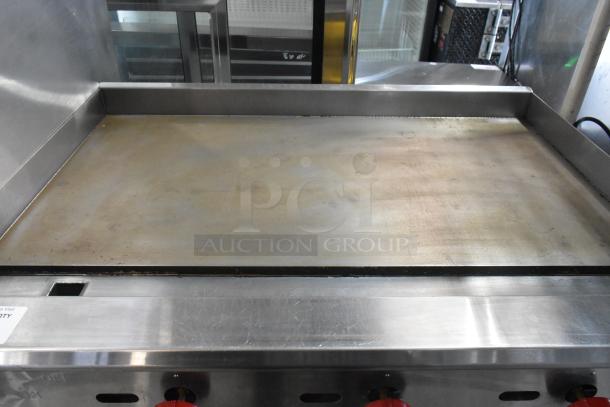 Cookline Stainless Steel Commercial Gas Griddle, flat top, countertop design, used condition, visible wear, red control knobs.