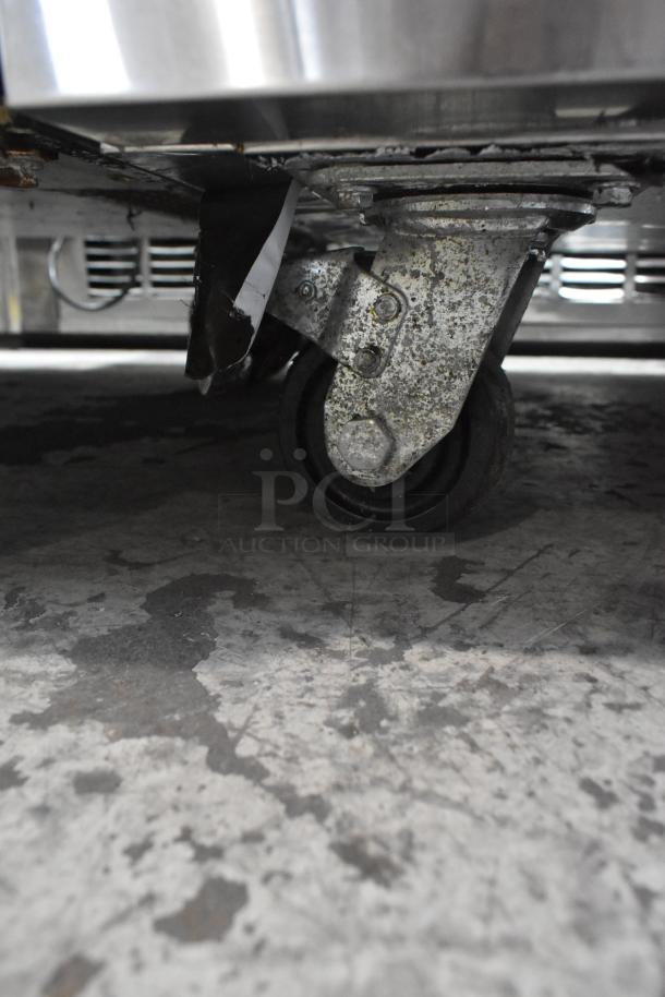 2023 Avantco 178CBE36HC stainless steel chef base on commercial casters, showing wear. 115 volts, 1 phase.