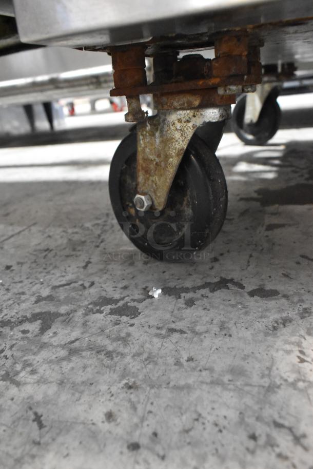 Close-up of a commercial caster wheel on a Southbend SilverStar stainless steel convection oven, rusty condition.