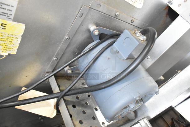 Rear view of Southbend SilverStar convection oven motor and wiring, showing stainless steel casing with wear and manufacturer label.