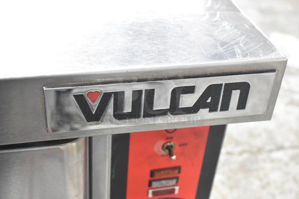 Vulcan VC6GD-SEFCA stainless steel commercial convection oven with metal racks and view-through doors. Brand logo visible.