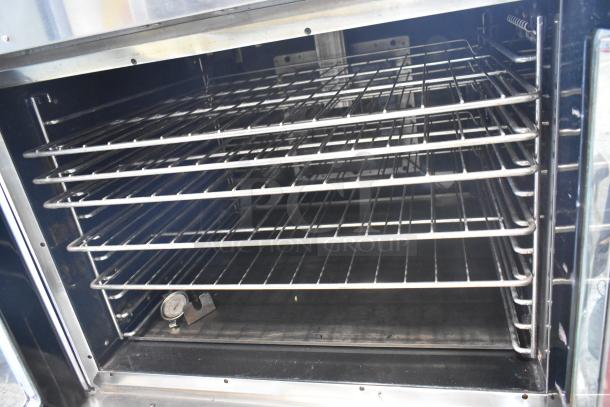 Vulcan VC6GD-SEFCA stainless steel commercial gas convection oven with metal racks and thermostatic control, interior view.