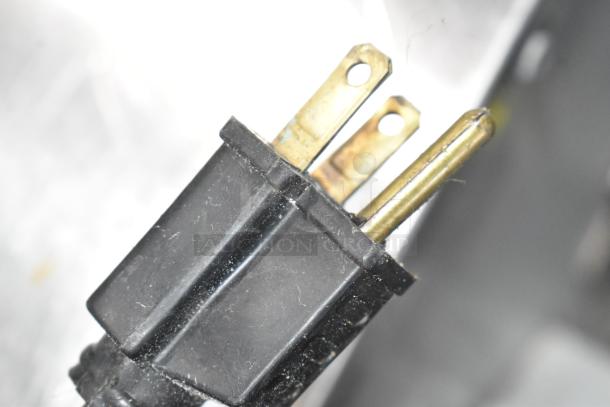 Three-prong power plug, close-up image, connected to Vulcan VC6GD-SEFCA convection oven.