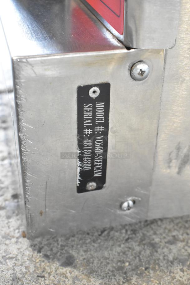Vulcan VC6GD-SEFCA gas convection oven, stainless steel. Features view-through doors, metal racks. Model and serial label visible.