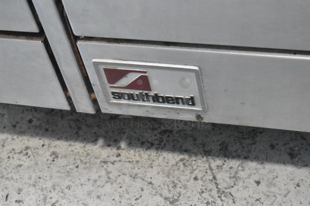 Southbend X460DD stainless steel commercial range, natural gas, 10 burners, 2 ovens, overshelf, backsplash. Brand label visible.