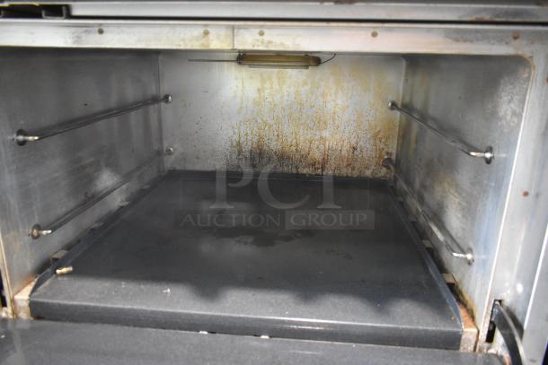 Southbend X460DD stainless steel commercial range interior, natural gas-powered, with visible wear and some discoloration.