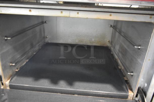 Inside view of Southbend X460DD natural gas oven. Stainless steel interior with two side racks, showing light use.