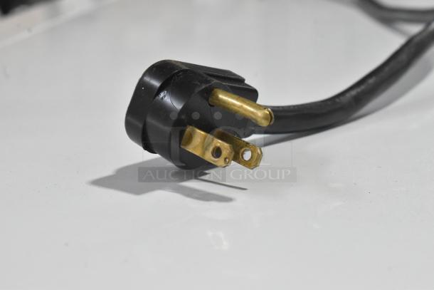 Close-up of a power plug for the Beverage Air BZ13-1-W merchandiser. Black cord, 115 volts, 1 phase.
