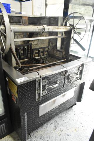 801 Metal Commercial Wood/Charcoal Charbroiler Grill on casters, model 801. Features metal construction with control handles.