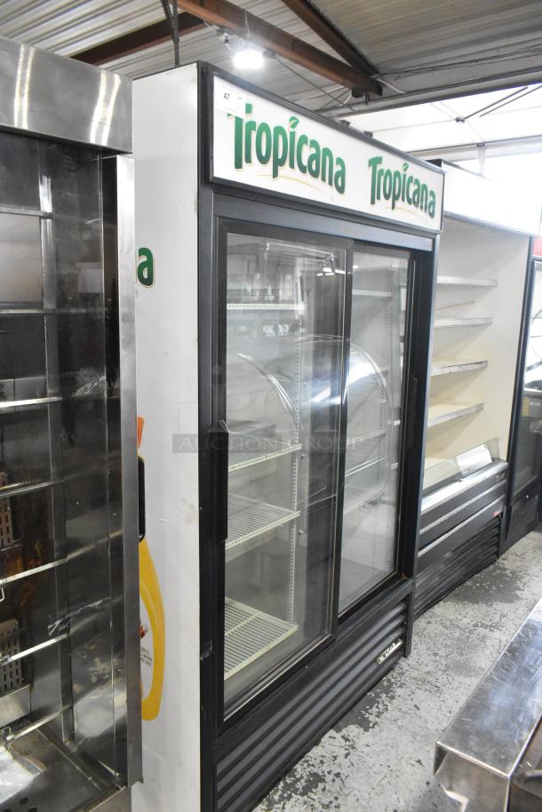 True GDM-45-LD commercial 2-door reach-in cooler with poly-coated racks. Features Tropicana branding. 115V, 1 Phase.