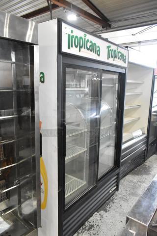 True GDM-45-LD commercial 2-door reach-in cooler with poly-coated racks. Features Tropicana branding. 115V, 1 Phase.