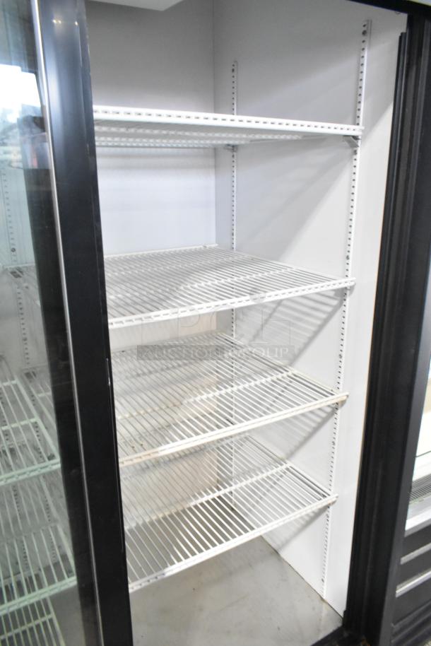 True GDM-45-LD commercial cooler, two glass doors, poly-coated racks, metal exterior, 115V, good condition.