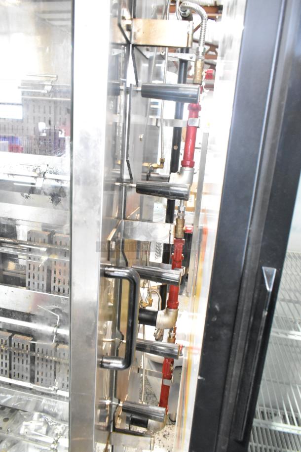 Southwood RG7 stainless steel commercial gas rotisserie oven, 6 spit, 114,000 BTU, on casters, excellent condition.