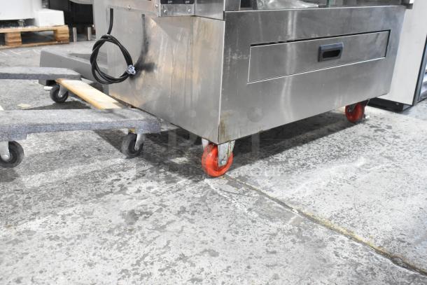 Southwood RG7 stainless steel rotisserie oven, natural gas, 6 spits, on commercial casters, 114,000 BTU.