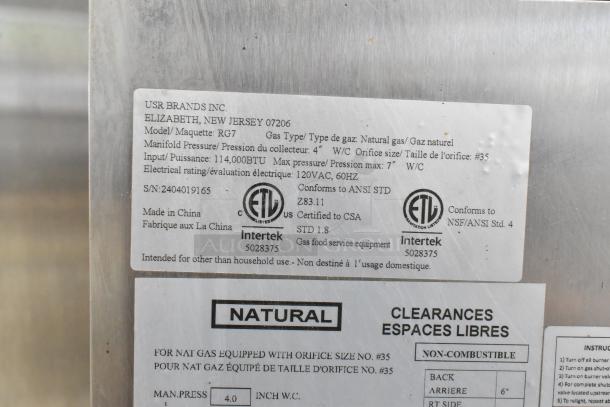 Southwood RG7 stainless steel commercial gas rotisserie oven, 6 spit, 114,000 BTU, on casters. Labels show specs and certifications.