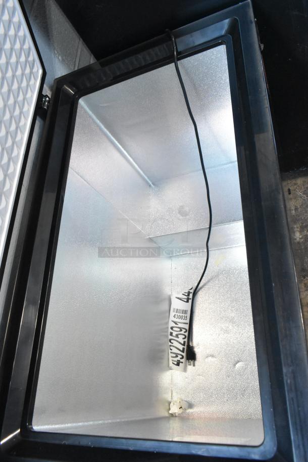 Frigidaire FGFRF7009-B-BLACK chest freezer with hinge lid, 115 volts, 1 phase, shown open. Clean interior, new condition.