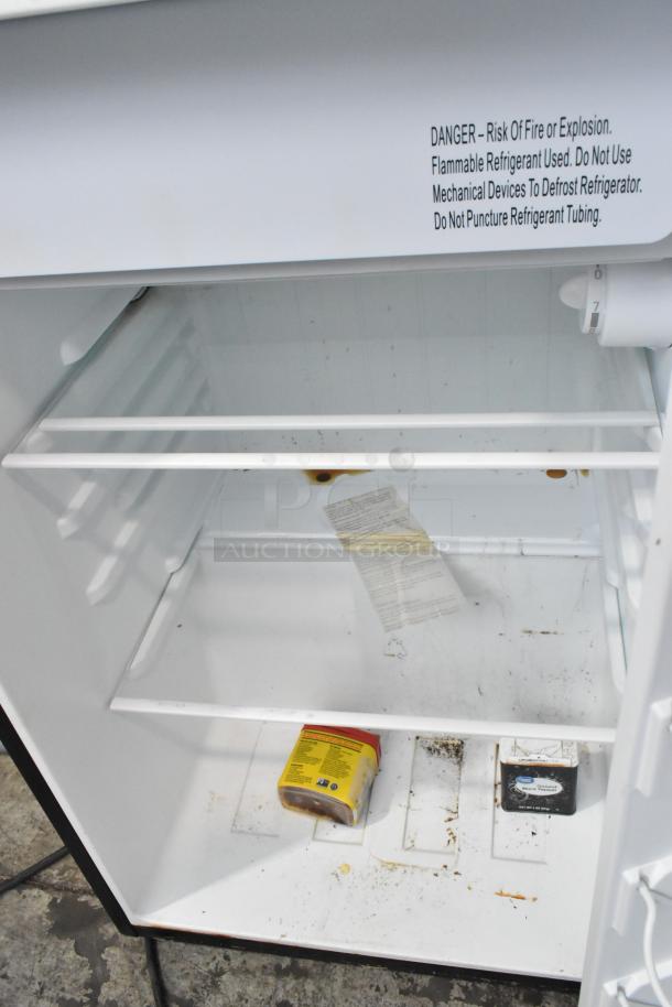 Galanz GL43S5 Mini Cooler, 115 Volts, 1 Phase. Interior shows stains and residue; contains a can and box. DANGER label inside.