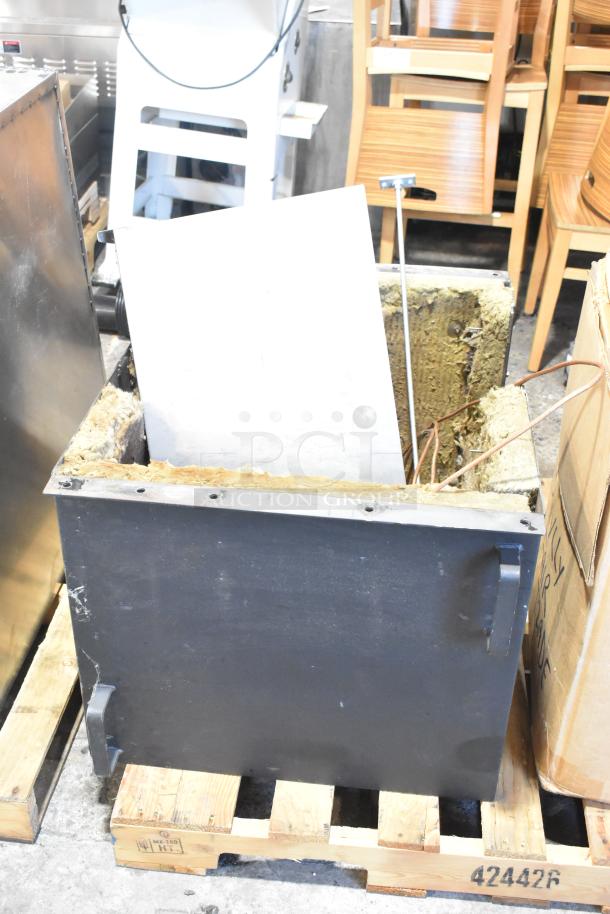 US Roaster Corp metal commercial roaster/smoker on pallet. Natural gas powered, 208-230/460 volts, 3 phase. Visible wear.