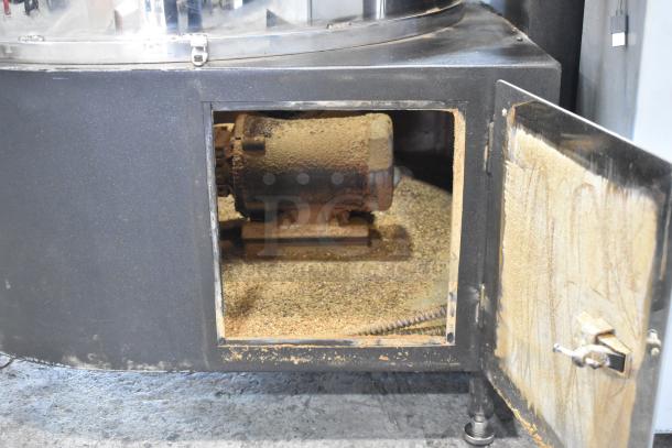 US Roaster Corp commercial gas roaster, metal with visible wear, open access panel revealing internal components.